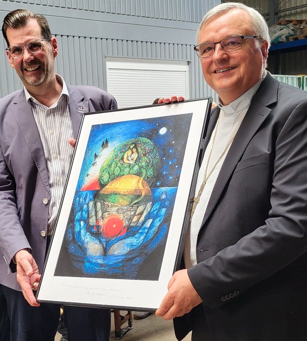 Bischof Karl-Heinz Wiesemann (rechts) überreicht ZAK-Vorstand Jan Deubig eine Schöpfungs-Darstellung des Priesters und Künstlers Sieger Köder